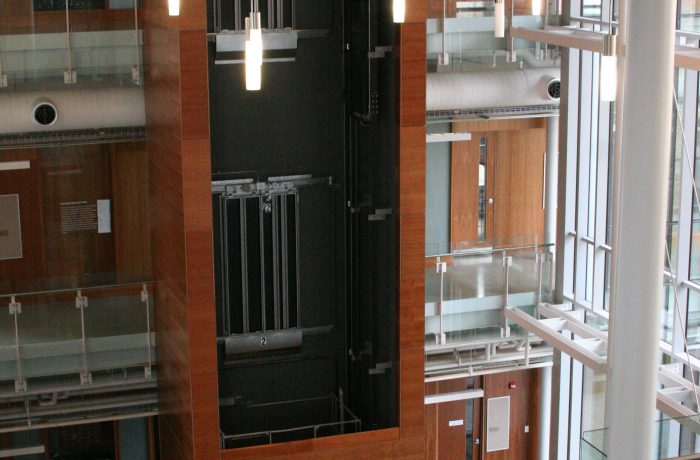 elevator surround with 3 floors of wood panels