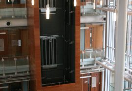 elevator surround with 3 floors of wood panels